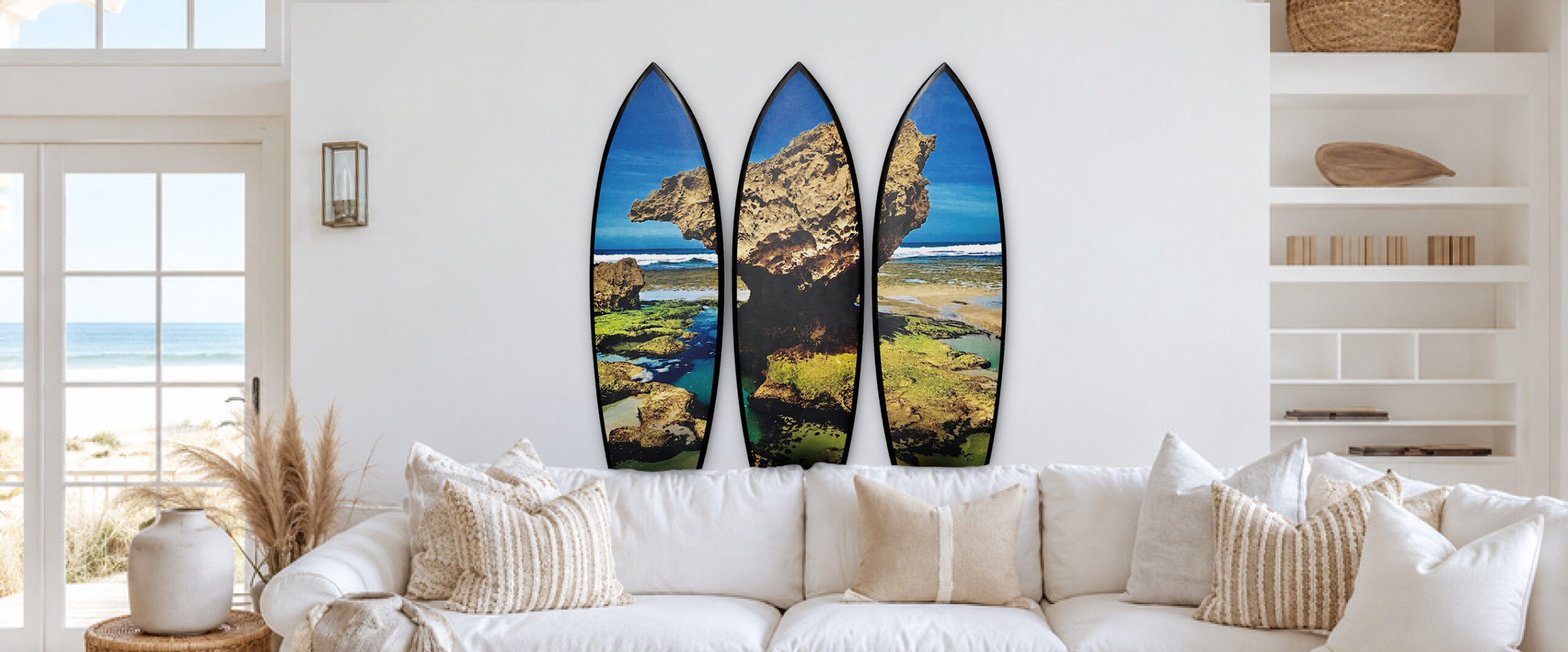 The three-piece Coastal Original surfboard artwork displayed in a bright living room